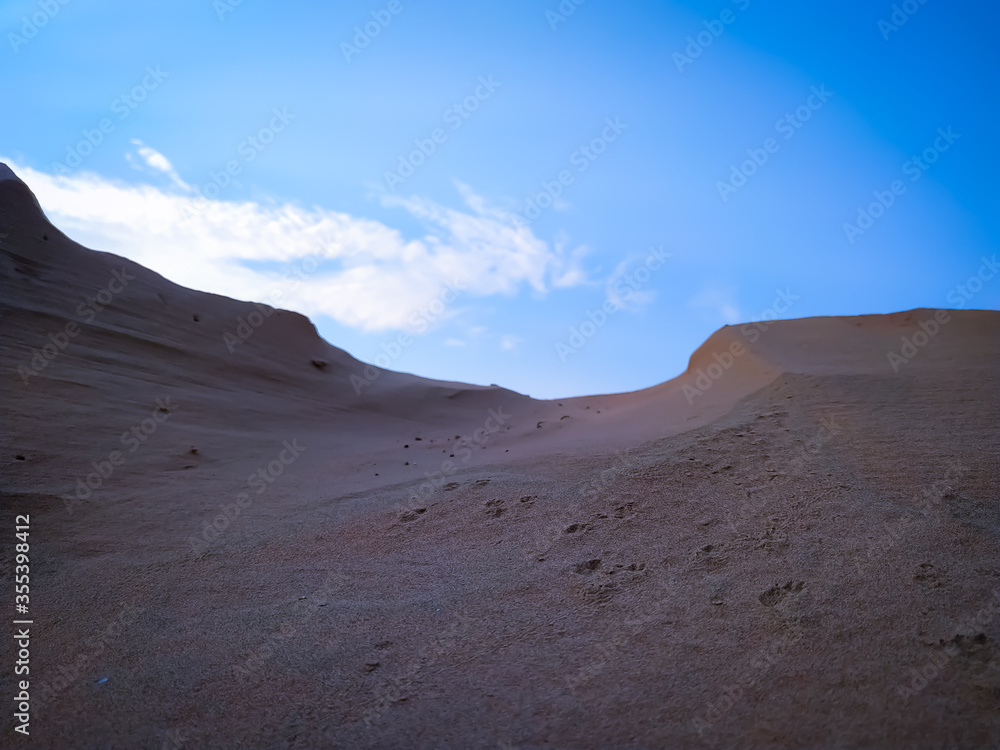 desert landscape with blue sky and clouds
