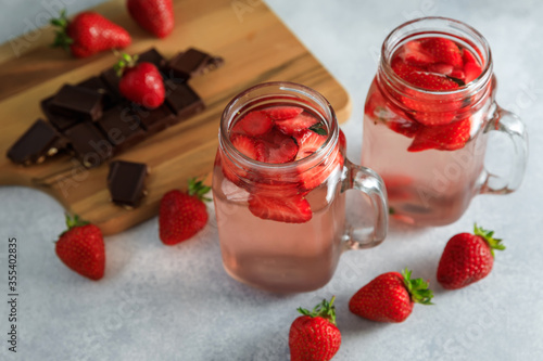 Strawberry drink with berriesand wooden board with chocolate. Diet drink, healthy concept