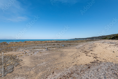 Empty Large Rocky Coastal Seaside Scene and Beach on a Sunny Day
