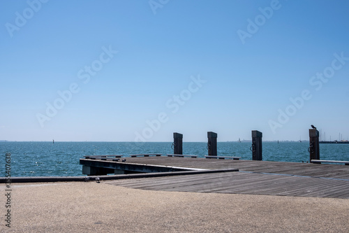 Empty Wooden Dock with Bollards Sea Scenery on a Bright Summer Day