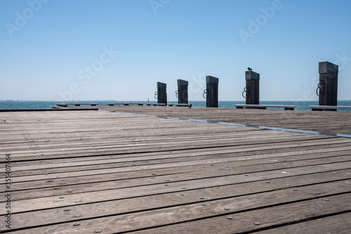 Empty Wooden Dock with Bollards Sea Scenery on a Bright Summer Day