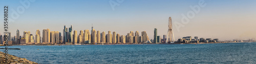 Wide panoramic view of the Arabian Gulf and Dubai's skyline, visible from The Palm Jumeirah Boardwalk before the sunset. Dubai, United Arab Emirates