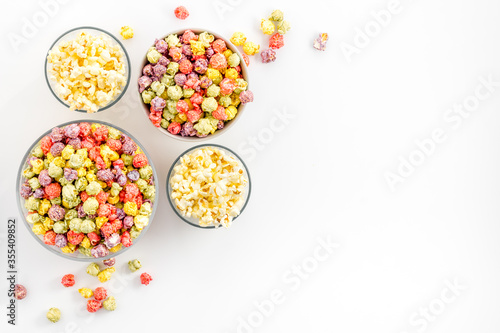 Flavored popcorn on white background top view space for text