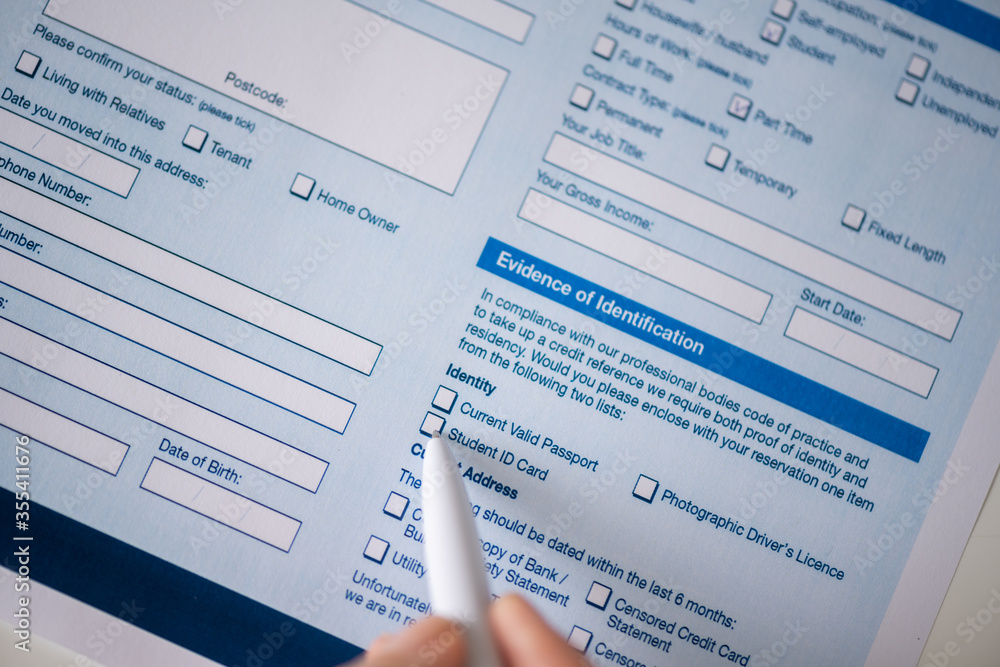 Woman filling contract, tick student id card in the graph evidence of identification. Close up. Selective focus. Woman filling contract, tick student id card in the graph evidence of identification. Close up. Selective focus.