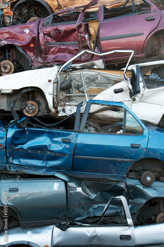 Stacked old cars on a junk yard, vertical image of car wrecks  © Marjolijn