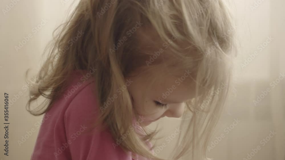 Beautiful little girl watching videos of herself on a smartphone Beautiful little girl watching videos of herself on a smartphone
