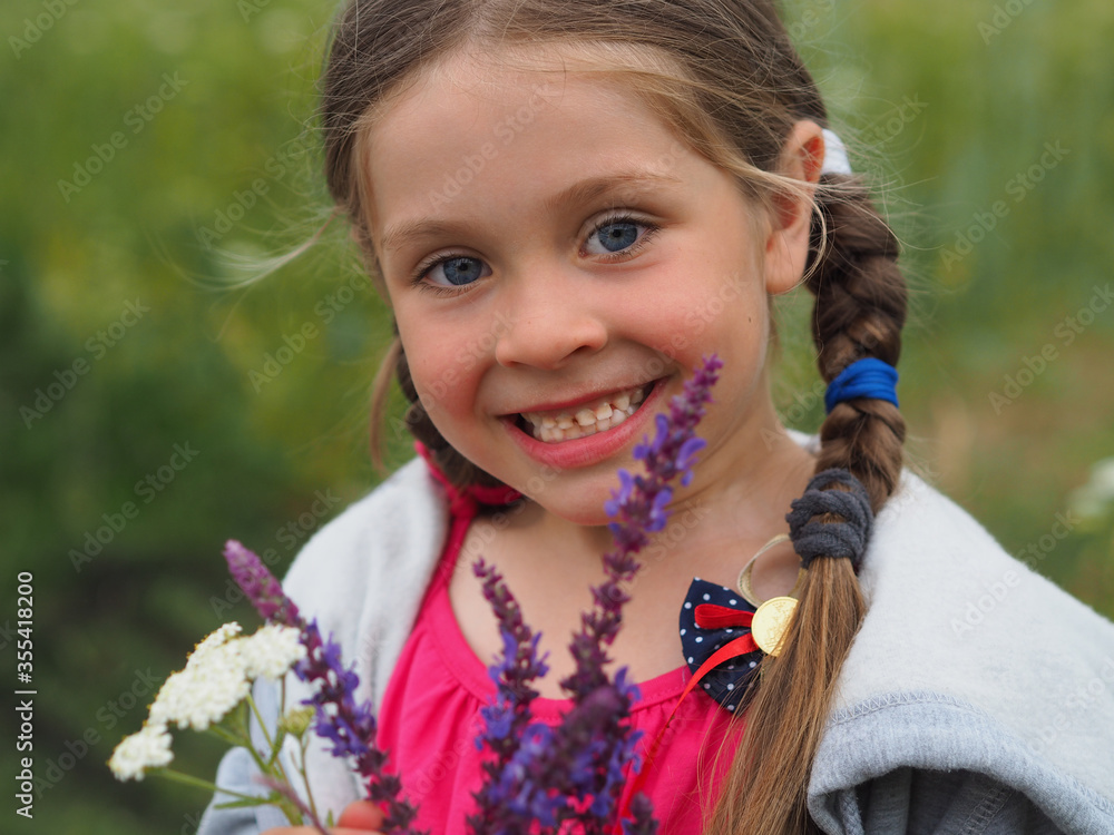 Portrait of a little girl with long blond hair blowing in the wind Portrait of a little girl with long blond hair blowing in the wind