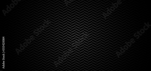 Abstract chevron pattern on black background with lighting photo