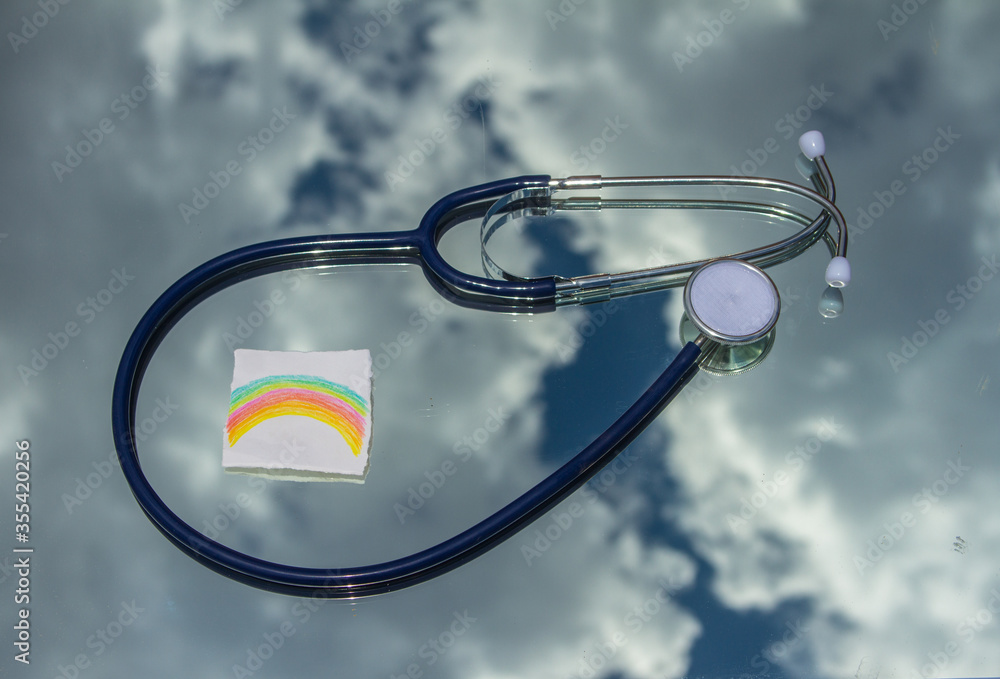 medical stethoscope with the background of clouds and rainbow drawn