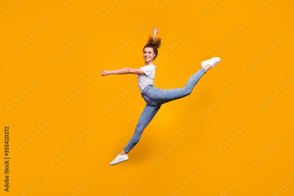 Full length body size view of her she nice attractive lovely perfect slender thin graceful curvy figure cheerful girl jumping dancing isolated on bright vivid shine vibrant yellow color background