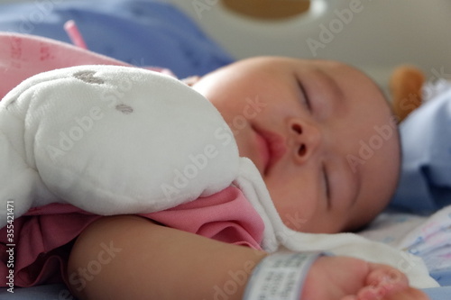 The sick boy was sleeping in a hospital bed. Boy is sick with Respiratory Syncytial Virus.