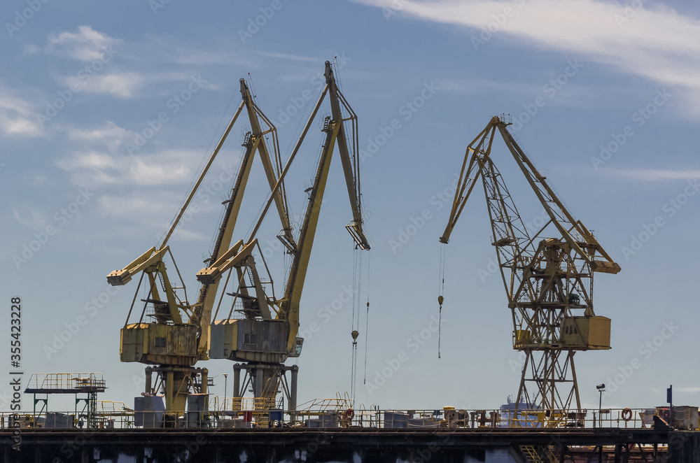 SHIPYARD AND SEAPORT - A set of port cranes at the port repair and reloading quays
SHIPYARD AND SEAPORT - A set of port cranes at the port repair and reloading quays