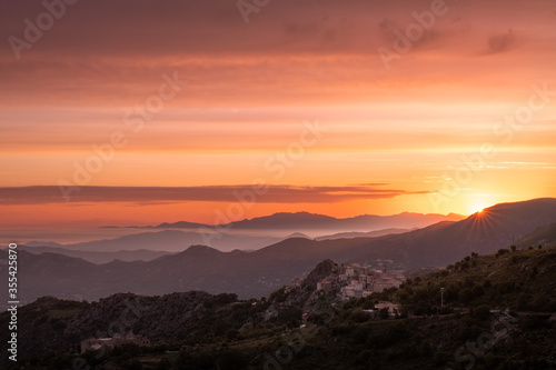 Sunrise over Speloncato and coastline of Corsica © Jon Ingall