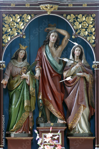 Saints Catherine, Sebastian and Lucia, statue on the altar of Saints Fabian and Sebastian at Our Lady of Miracles Parish Church in Ostarije, Croatia