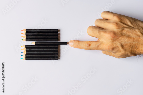 Obsessive compulsive disorder, male hand obsessively ordering some colored pencils
Conceptual psychological problem, OCD photo