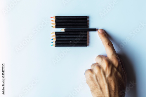 Obsessive compulsive disorder, male hand obsessively ordering some colored pencils
Conceptual psychological problem, OCD photo
