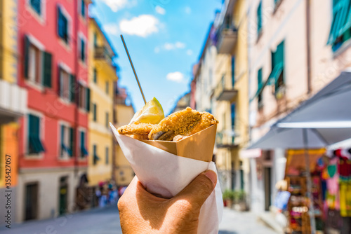 Fototapeta Naklejka Na Ścianę i Meble -  Fritto misto di pesce (Mixed fried fish) with Cinque Terre village background