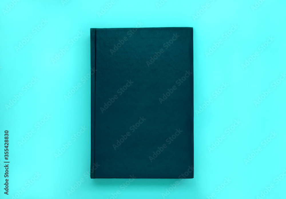 Minimal black leather book cover mock up on blue background. Minimal black leather book cover mock up on blue background.