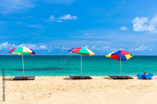 Fototapeta Naklejka Na Ścianę i Meble -  beach umbrella and ring on beach with blue sky, phuket thailand