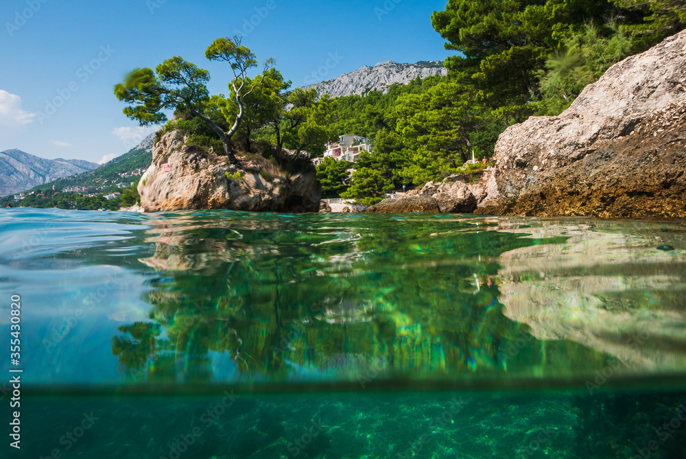 Semi underwater photography of holiday resort Brela in Croatia, famous Brela Rock, Punta Rata Beach, Makarska Riviera.