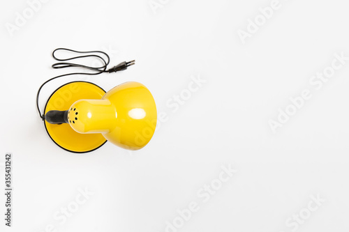 Vintage yellow table (desk) lamp isolated on white background. High-resolution photo.