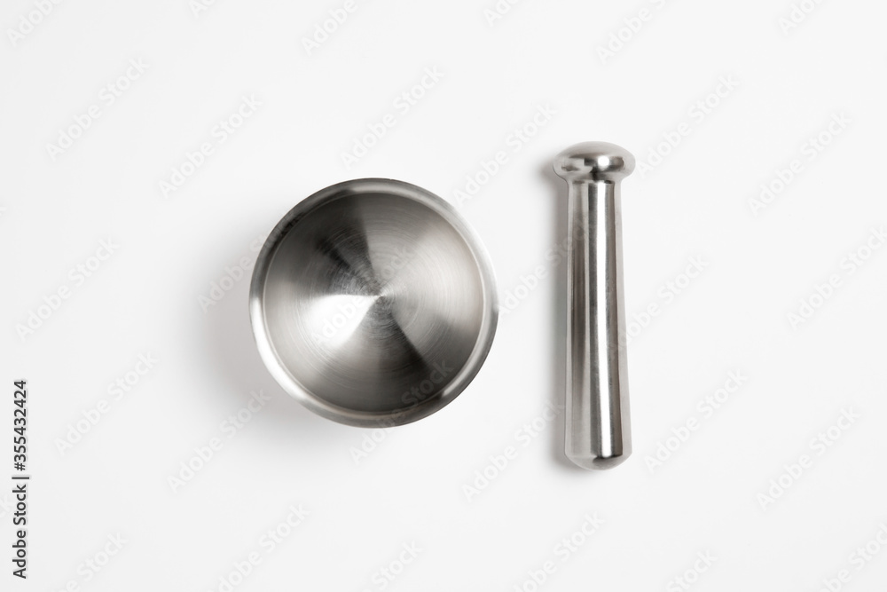 Metal, steel mortar with a pestle for herbs.Cooking tool. High-resolution photo.