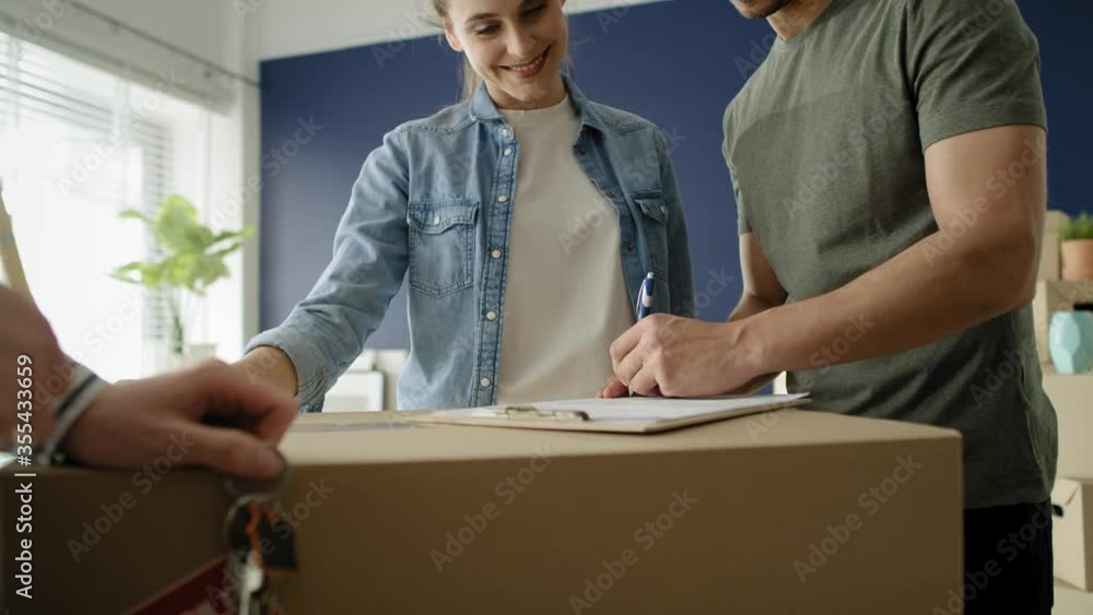 Handheld video of young couple signing a house purchase agreement. Shot with RED helium camera in 8K Handheld video of young couple signing a house purchase agreement. Shot with RED helium camera in 8K
