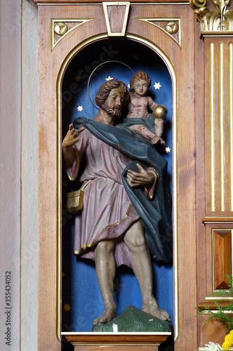 St. Christopher, statue on the altar of St. Vitus in the parish church of St. Nicholas in Scitarjevo, Croatia photo