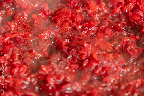 Raw grated beets stewed in a pan  steam  background
