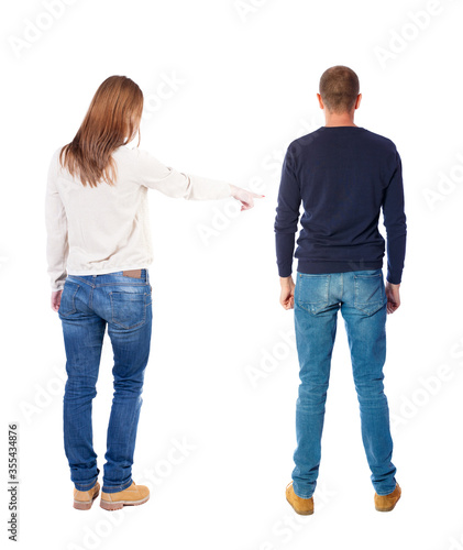 Back view of couple in sweater pointing.