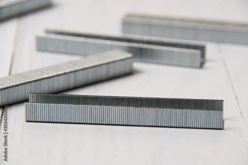 Construction braces on a light wooden background with copy space. The concept of construction, repair, improvement of housing conditions Construction braces on a light wooden background with copy space. The concept of construction, repair, improvement of housing conditions