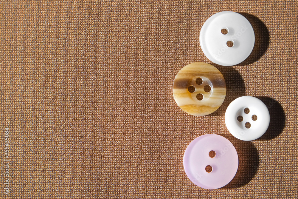 Group button on brown cloth for sew top view with copy free space for text close-up. Group button on brown cloth for sew top view with copy free space for text close-up.