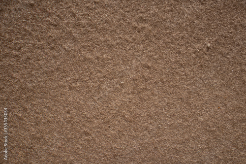  texture of a carpet color brown.