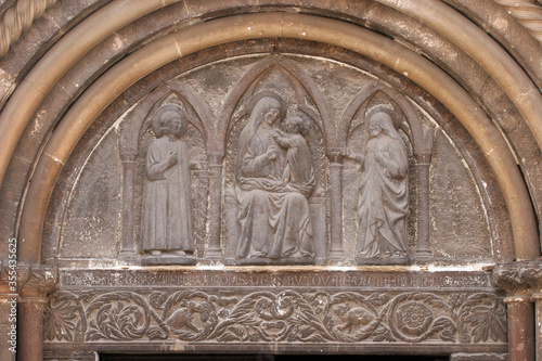 Gothic relief of the Virgin and Child, on the right is St Anastasia, and to the left St Chrysogonus, Cathedral of St Anastasia in Zadar, Croatia photo