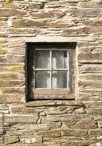 Old square window frame and stone wall in building in Felindre Farchog, near Newport. Pembrokeshire, Wales. UK