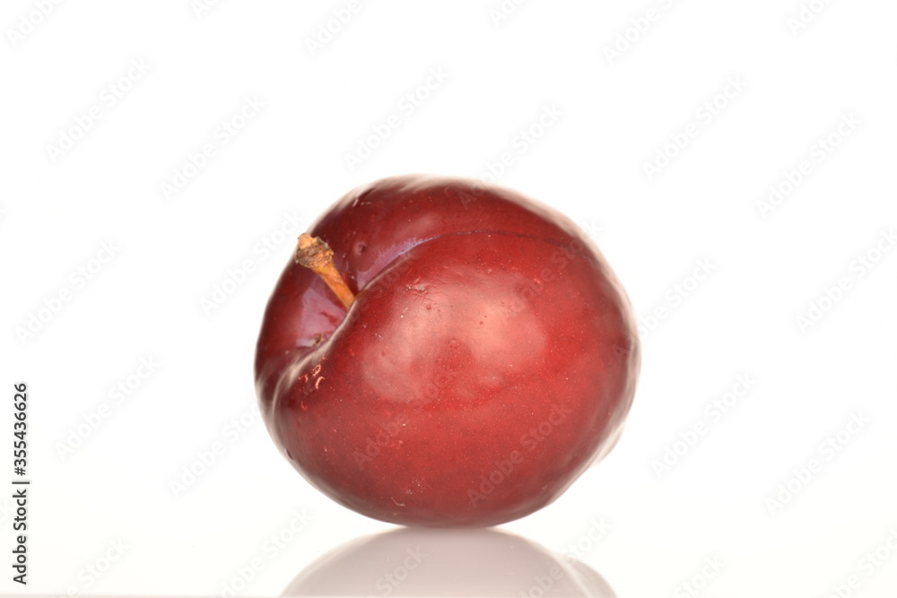 Juicy, tasty, organic red plum, close-up, on a white background. Juicy, tasty, organic red plum, close-up, on a white background.