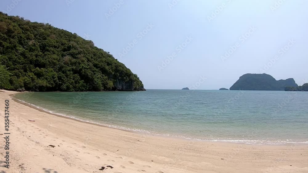 The Video moves from left to the right side of Sandy beaches and light waves in the bay Background sea and island on koh Kula , Chumphon , Thailand. The Video moves from left to the right side of Sandy beaches and light waves in the bay Background sea and island on koh Kula , Chumphon , Thailand.