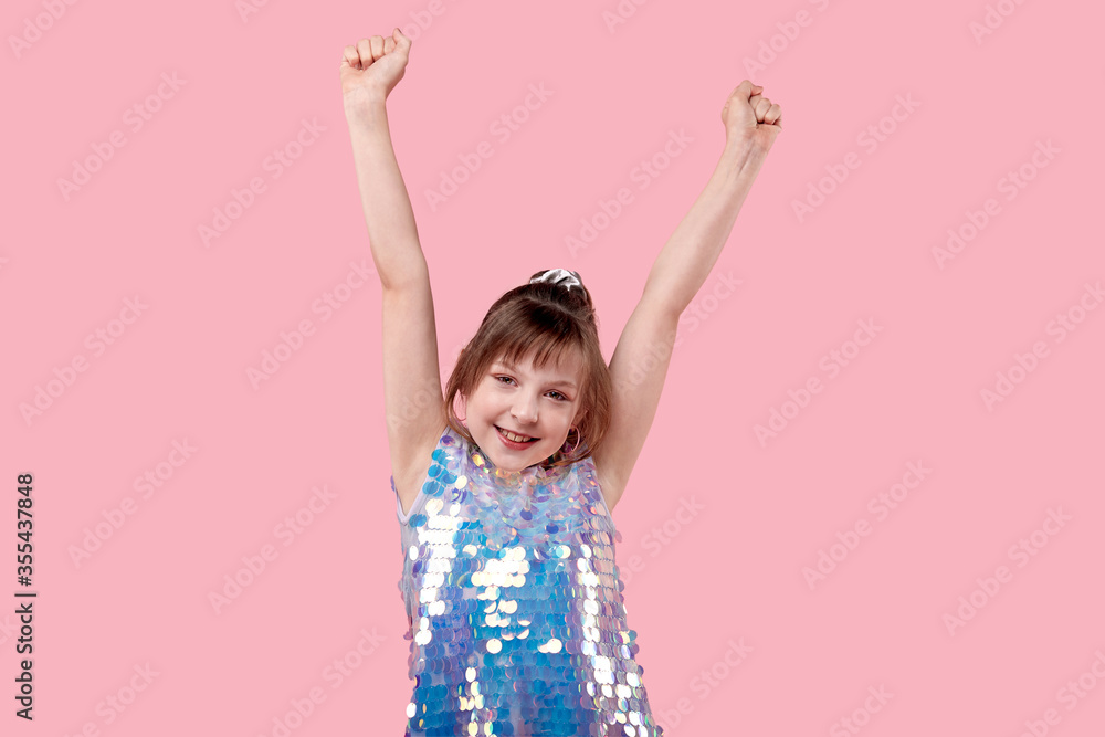 A cheerful dancing girl with her hands up. A cheerful dancing girl with her hands up.