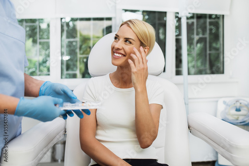 Fotografie Beautiful and happy blonde woman at beauty medical clinic