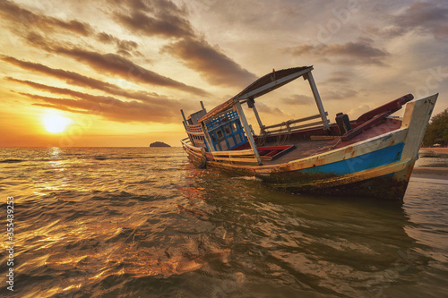Beached fishing boat during sunset at Otres beach in Sihanoukville
