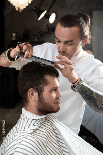 Men's hairstyling and haircutting in a barber shop or hair salon.
