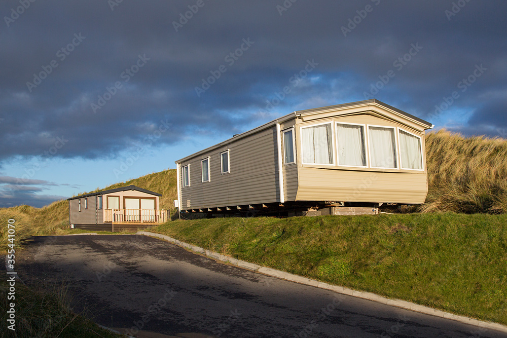 Static caravan holiday homes at Llangennith on the Gower Peninsular in winter which is out of season, the caravans are closed up until spring. Static caravan holiday homes at Llangennith on the Gower Peninsular in winter which is out of season, the caravans are closed up until spring.
