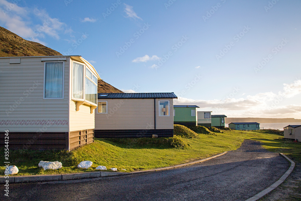 Static caravan holiday homes at Llangennith on the Gower Peninsular in winter which is out of season, the caravans are closed up until spring.