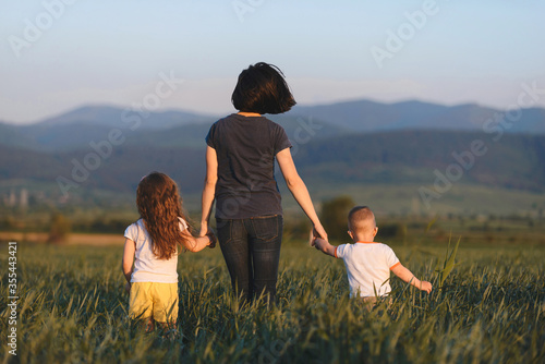 mother walking away with children