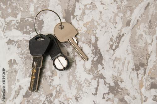 Keys to the apartment or house, intercom key on a light wooden background.