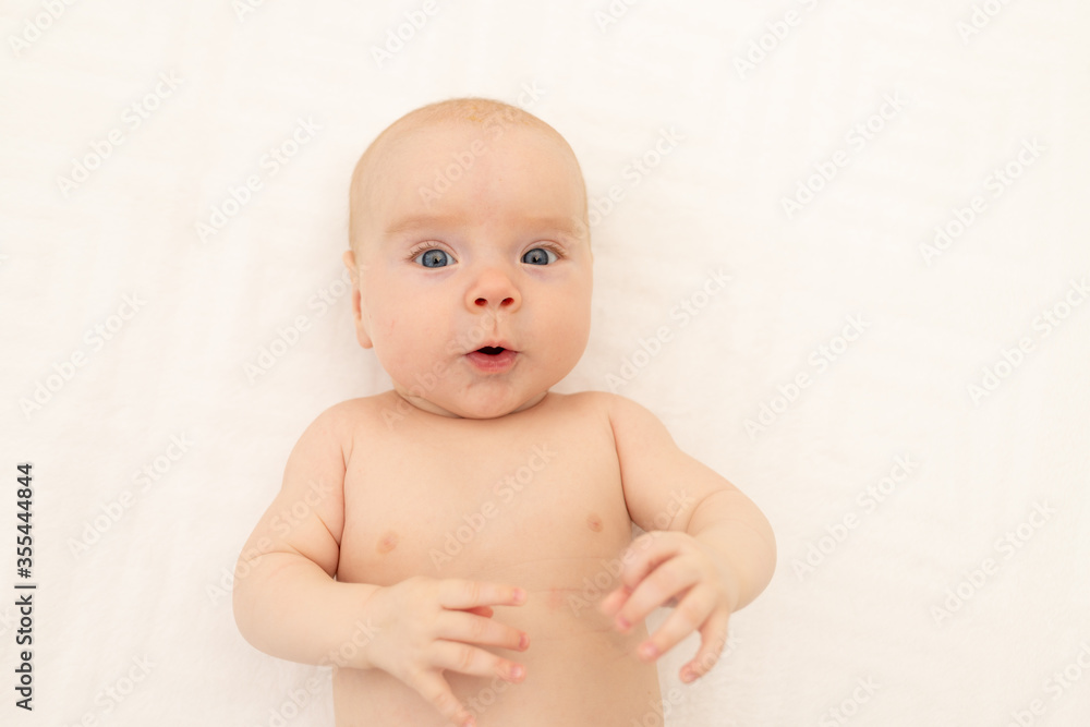 portrait of a child on a white background. Bedding for children. 6 months. Healthy baby in the crib. Space for text portrait of a child on a white background. Bedding for children. 6 months. Healthy baby in the crib. Space for text