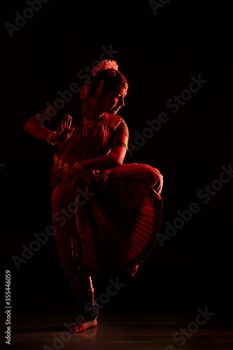Bharatanatyam dancer doing Nataraja mudra during her performance on stage photo