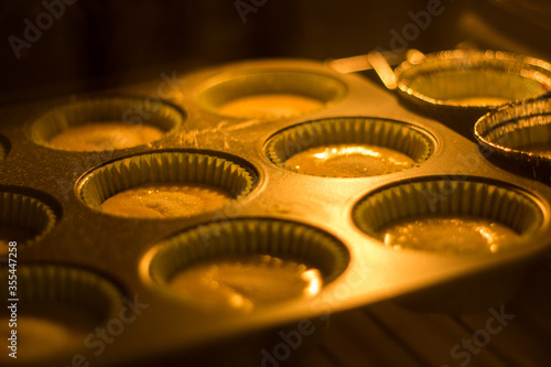 Preparing cupcakes in the oven