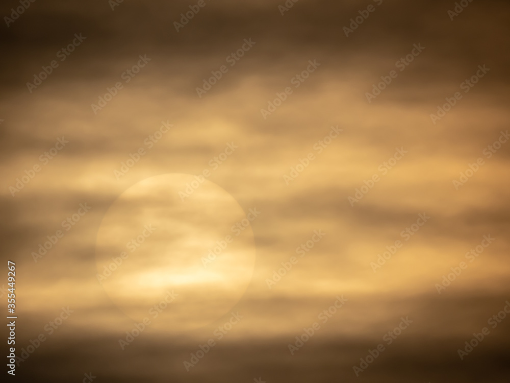 cold sun peeking through the dark storm clouds following rule of thirds cold sun peeking through the dark storm clouds following rule of thirds