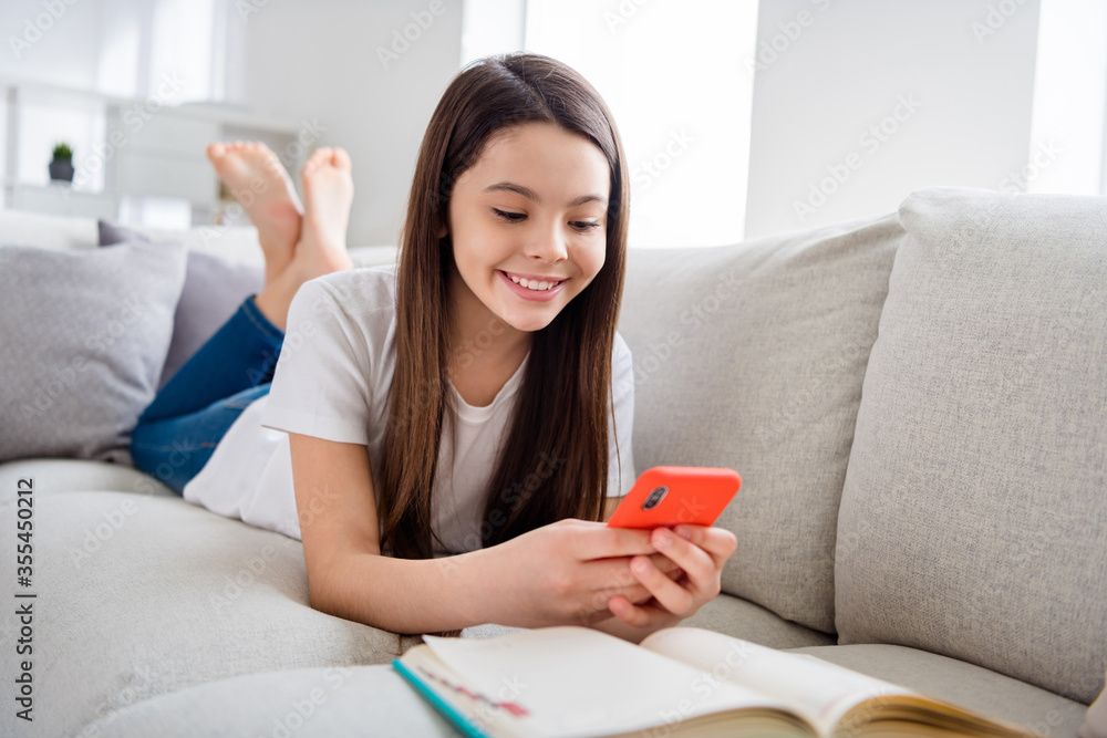 Photo of little pretty pupil school lady chatting telephone classmates friends wait online lesson lying sofa homey domestic social distance home quarantine study comfort room indoors Photo of little pretty pupil school lady chatting telephone classmates friends wait online lesson lying sofa homey domestic social distance home quarantine study comfort room indoors